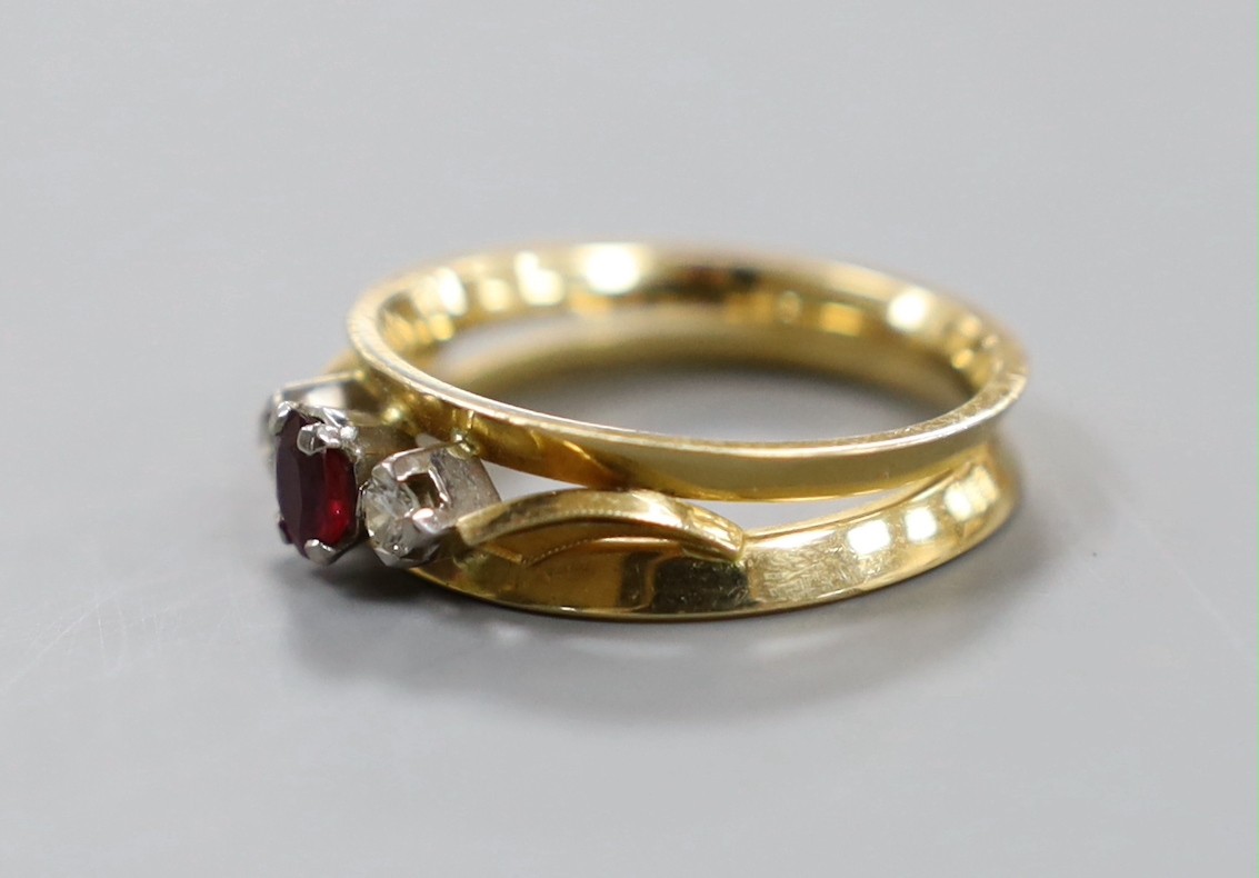 A modern 18ct, ruby and diamond set three stone ring, size Q, gross weight 5.7 grams.